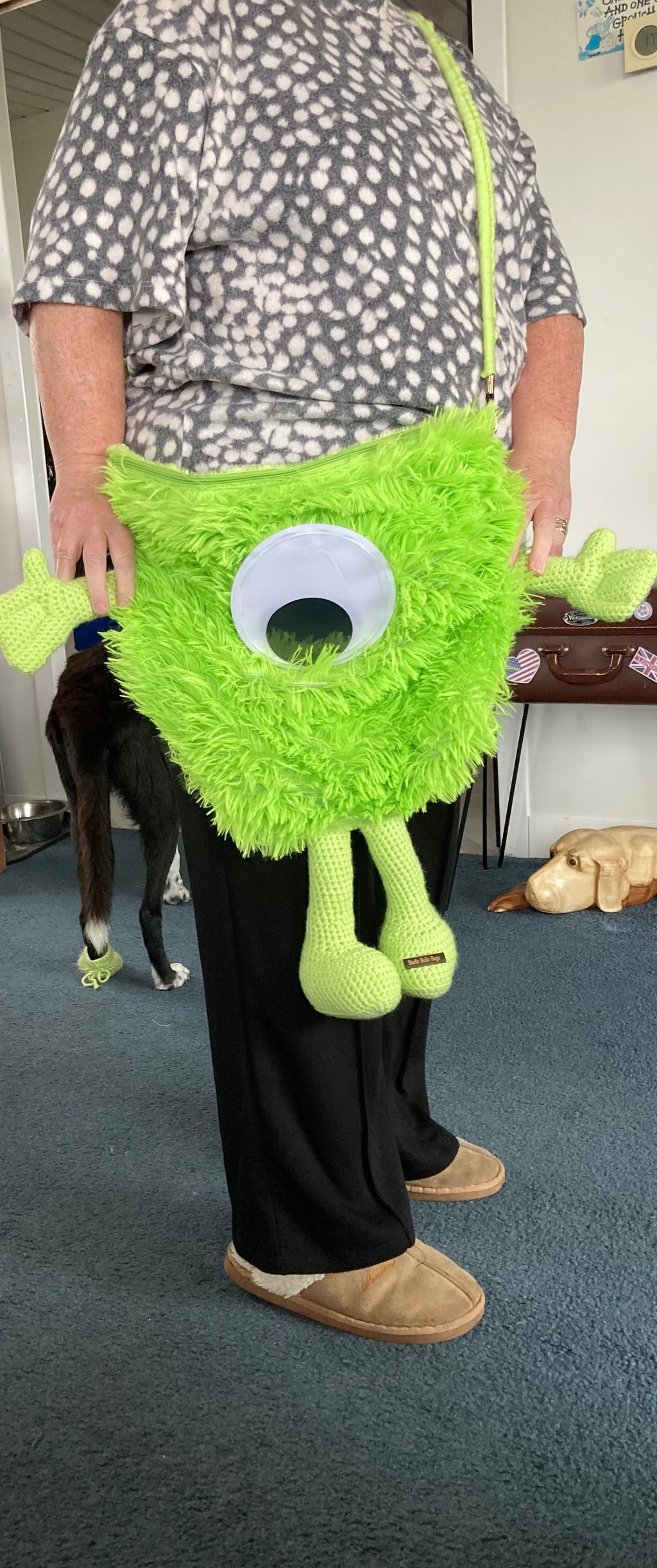 Green monster over shoulder bag