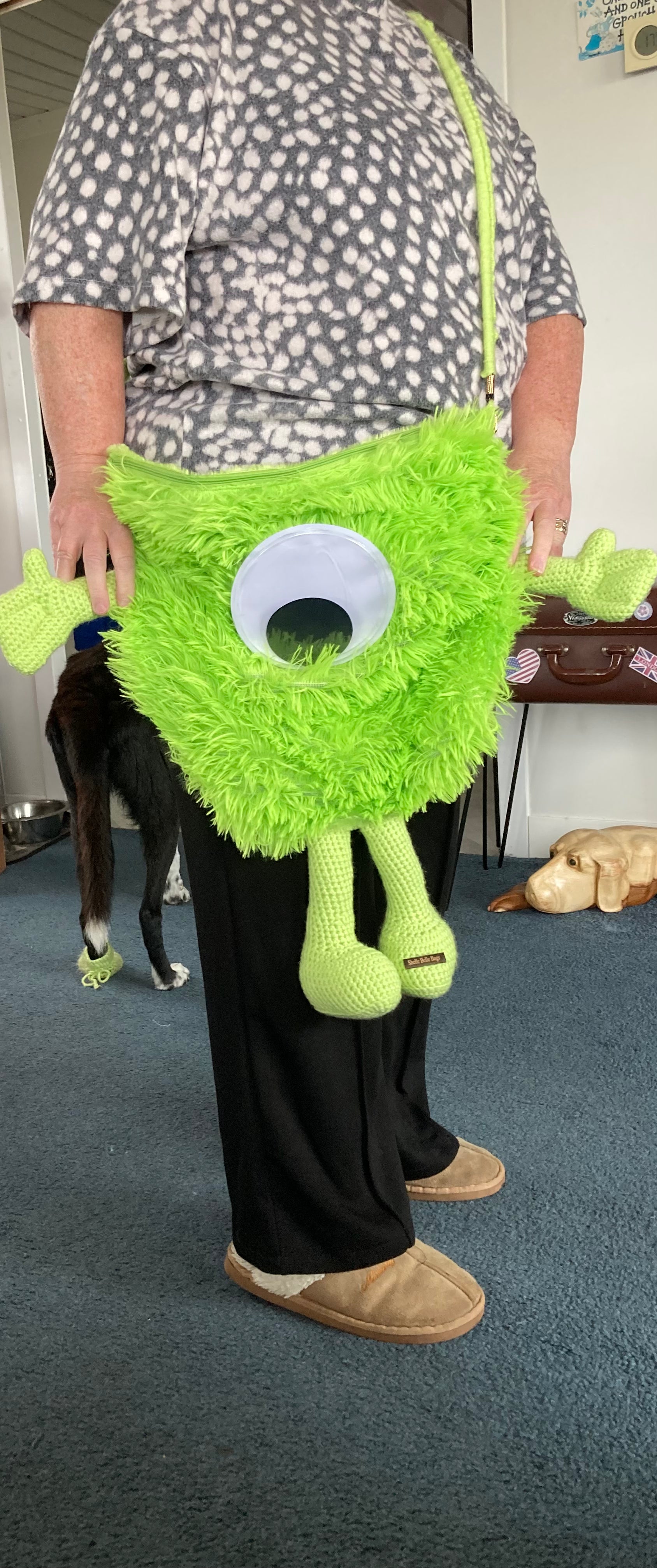 Green monster over shoulder bag