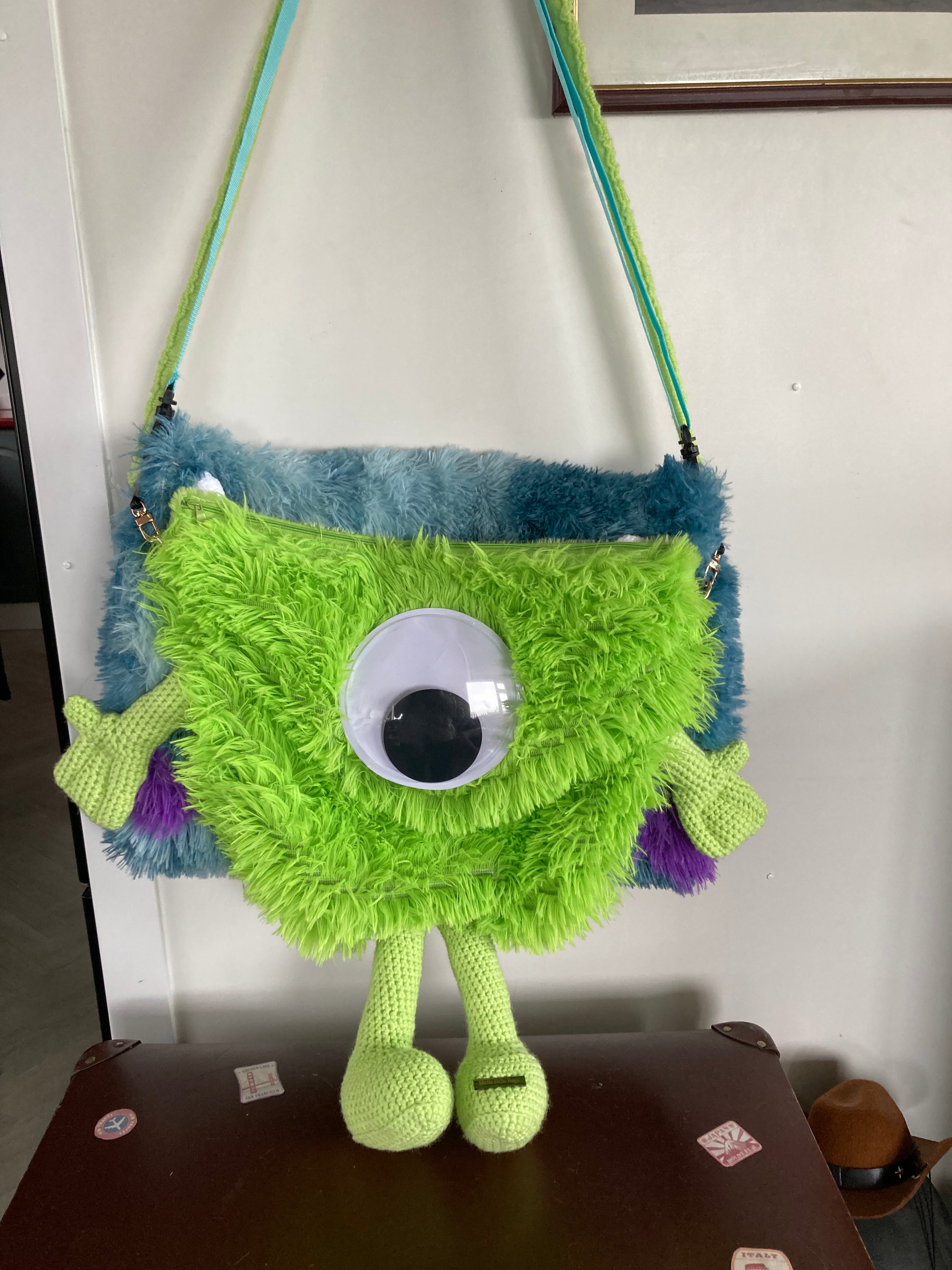 Green monster over shoulder bag