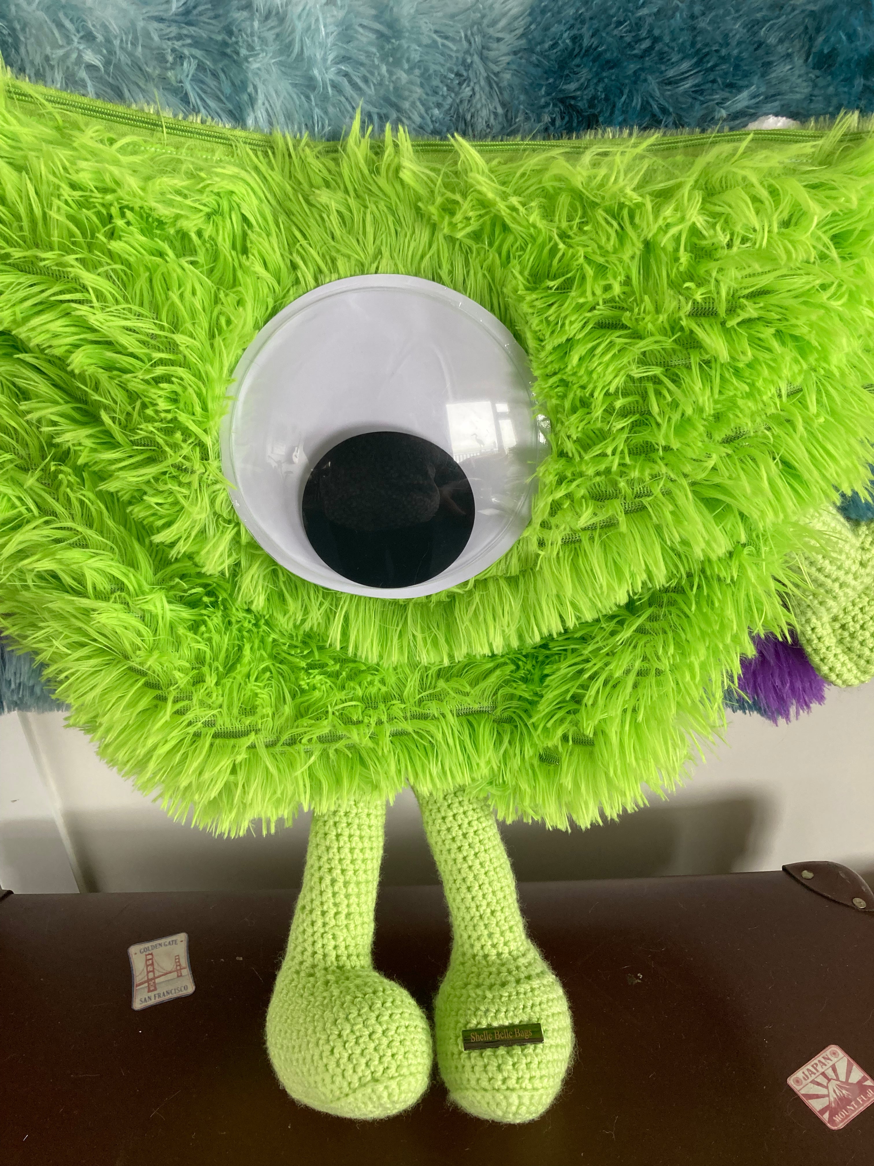 Green monster over shoulder bag