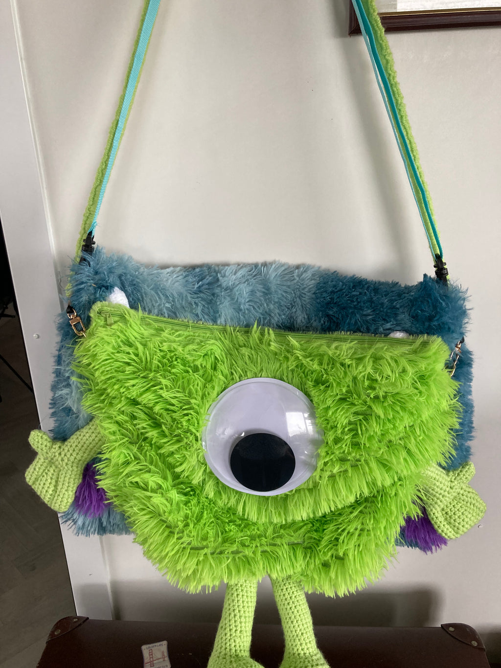 Green monster over shoulder bag